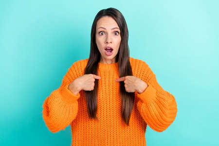 Photo of impressed mature brunette lady index herself wear orange pullover isolated on turquoise...