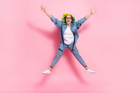 Full length body size view of attractive cheerful wavy-haired girl jumping fooling isolated over...