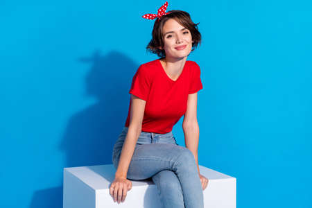 Photo of young lovely woman enjoy dream think wear modern outfit isolated over blue color backgroundの写真素材