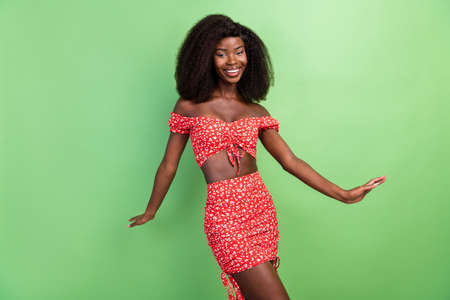 Photo of lovely young wavy hairdo brunette lady dance wear red outfit isolated on green color backgroundの写真素材