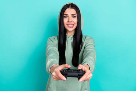 Photo of sad millennial brunette lady playstation wear green sweatshirt isolated on teal color...