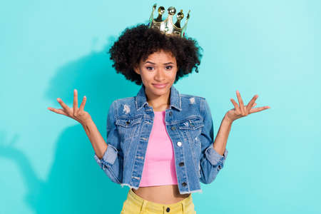 Photo of stressed depressed young woman wear jeans jacket crown rising arms isolated turquoise color backgroundの写真素材