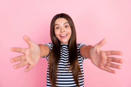 Photo of cute friendly girl dressed striped clothes open arm ready hug you isolated pink color backgroundの写真素材