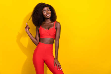 Photo of adorable flirty african lady dressed red sexy clothes smiling arm hair curl empty space...