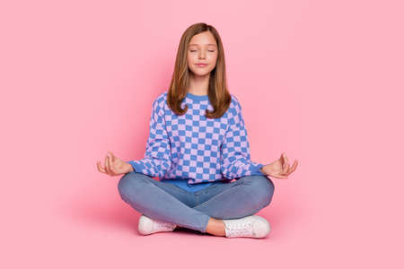 Full size photo of young pretty girl sit lotus pose meditate relax practicing isolated over pink color backgroundの写真素材