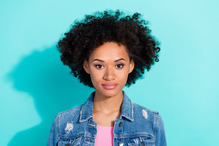Photo of charming shiny young lady dressed denim jacket smiling isolated teal color backgroundの写真素材