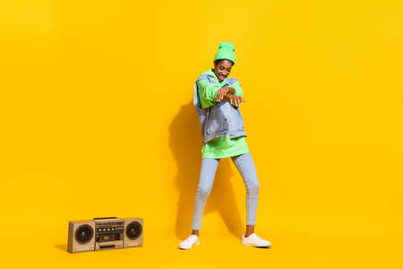 Full length portrait of positive cheerful person enjoy clubbing good mood isolated on yellow color...