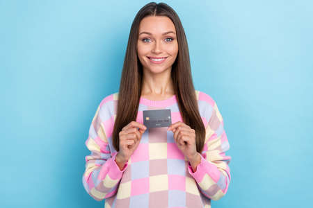 Photo of confident financial investor lady hands demonstrate debit card wear sweater isolated blue...