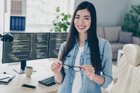 Portrait of attractive cheerful intellectual girl ceo boss chief expert web designer tech engineer at work place station indoors.の写真素材