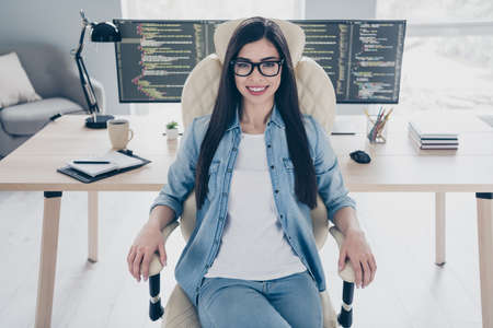 Portrait of attractive cheery skilled intellectual girl tech support web designer sitting in...