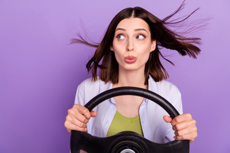 Photo of impressed brunette millennial lady drive car look empty space wear shirt top isolated on...