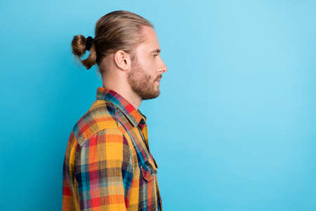 Profile photo of nice young tail hairstyle guy look promotion wear plaid shirt isolated on blue color backgroundの写真素材