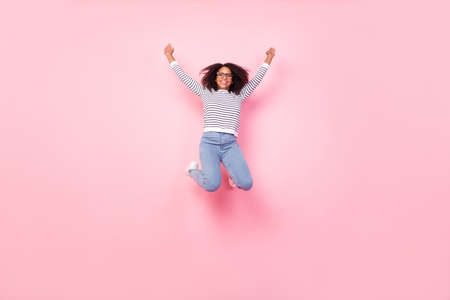 Full size photo of cheerful sportive lady raise fists success achieve isolated on pink color...
