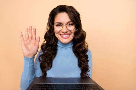 Photo of cute charming lady dressed blue pullover glasses waving arm video call device isolated...