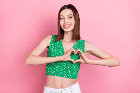 Photo of young cheerful lady show fingers heart symbol cupid romantic isolated over pink color...
