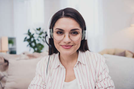 Portrait of attractive cheerful skilled experienced woman answering customer call insurance staying...