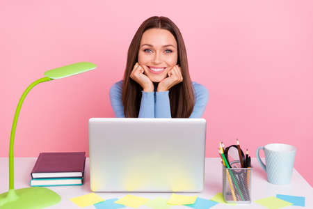 Photo of lady agent sit desk enjoy remote study coach use netbook wifi connection isolated over pastel color backgroundの写真素材