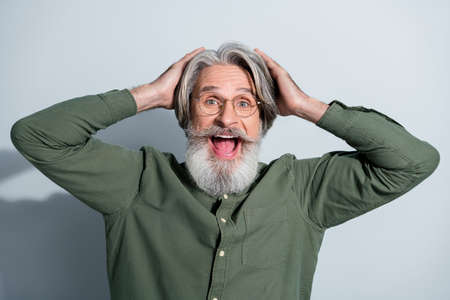 Portrait of attractive cheerful overjoyed crazy grey-haired man great news emotion isolated over...