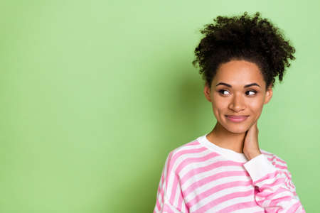 Photo of tender sincere dream lady hand neck look empty space wear striped shirt isolated green color backgroundの写真素材