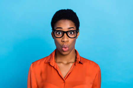 Photo of shocked funky lady unexpected discount reaction wear specs brown shirt isolated blue color backgroundの写真素材