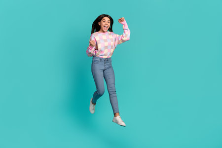 Full length body size view of attractive cheerful girl jumping rejoicing having fun isolated over...