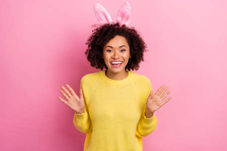Photo of cute excited lady wear yellow sweater easter headband rising arms isolated pink color backgroundの写真素材