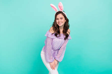 Portrait of attractive cheerful girl wearing ears posing having fun good mood isolated over bright...