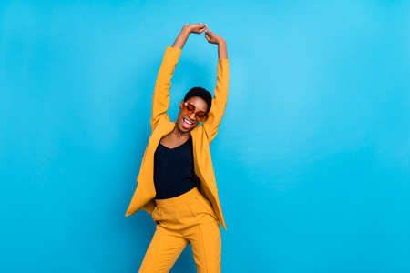 Portrait of carefree positive person enjoy partying spend pastime isolated on blue color backgroundの写真素材