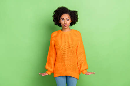 Photo of flirty millennial volume hairdo lady blow kiss wear orange jumper jeans isolated on green color backgroundの写真素材