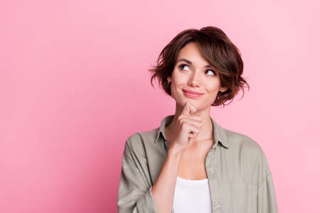 photo of minded lady touch hand chin look empty space choose intelligent choice isolated pastel color backgroundの写真素材