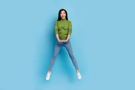 Full length body size view of attractive cheerful glad slim girl jumping having fun isolated over...
