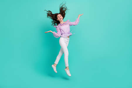 Full body photo of satisfied adorable person hands throw hair have fun isolated on turquoise color backgroundの写真素材