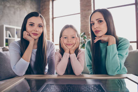 Photo of attractive mommy with daughters speak conversation video laptop meeting relatives flat indoorsの写真素材