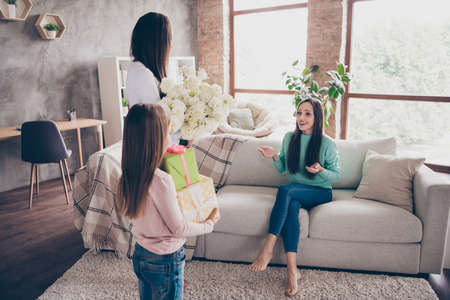 Photo of pretty mature woman unexpected reaction sitting divan living-room gift spring bunch flower indoorsの写真素材