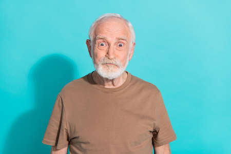 Portrait of attractive funky amazed grey-haired man staring eyes isolated over vibrant blue color...