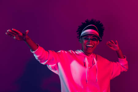 Portrait of attractive cheerful trendy girl dancing rest having fun isolated on bright multicolor light gradient color backgroundの写真素材