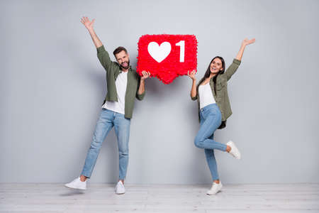 Full length photo of carefree lady guy blogger enjoy blog popular repost hands up hold paper heart...