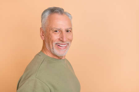 Profile side photo of cheerful mature man smart agent promoter wear casual clothes isolated over...