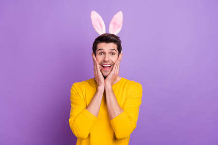 Photo of cheerful laughing young man with bunny ears see huge bargains on black friday isolated on...