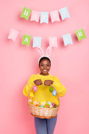 Portrait of cheerful friendly person hands hold easter basket toothy smile isolated on pink color...