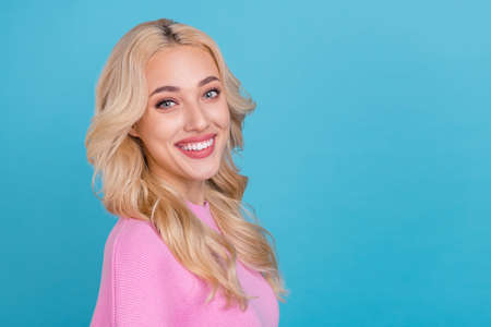 Profile side view portrait of attractive cheerful wavy-haired girl copy space isolated over bright...