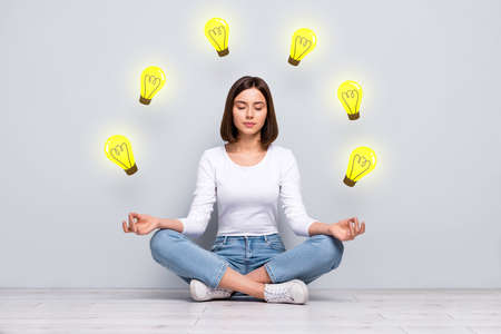 Teamwork business collaboration problem solving concept young girl sitting floor lotus position meditating inner harmony brilliant ideaの写真素材
