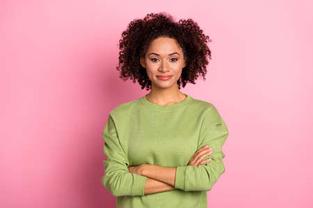 Portrait of attractive wavy-haired content girl wearing sweatshirt folded arms isolated over pink pastel color backgroundの写真素材