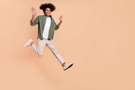 Full size profile photo of cheerful overjoyed person free time good mood isolated on beige color backgroundの写真素材