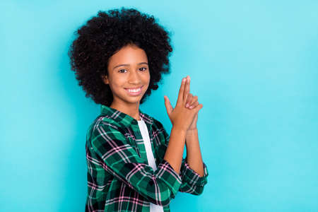 Photo of funny player lady hold fingers pistol shape have fun wear checkered shirt isolated teal color backgroundの写真素材