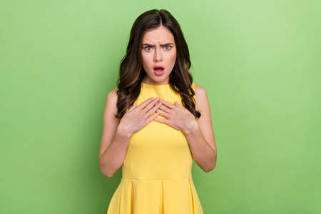 Portrait of attractive worried fury wavy-haired girl negative bad reaction isolated over bright green color backgroundの写真素材