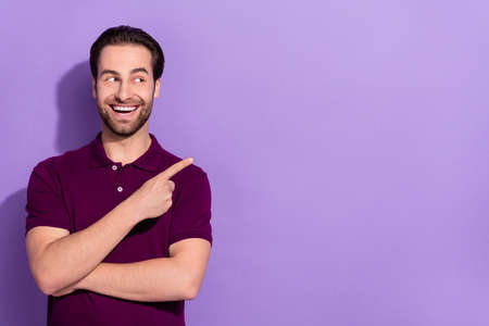 Photo of funny cheerful young man promote black friday big sales shopping lover isolated on violet color backgroundの写真素材