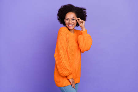 Portrait of attractive intellectual cheery girl posing touching specs isolated over bright purple violet color backgroundの写真素材