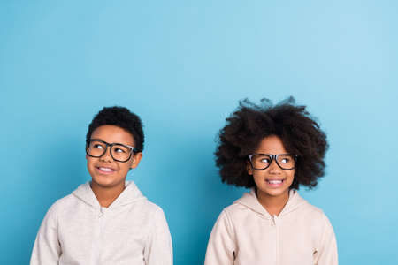 Portrait of attractive cheerful brainy friends friendship creating solution copy space isolated over bright blue color backgroundの写真素材