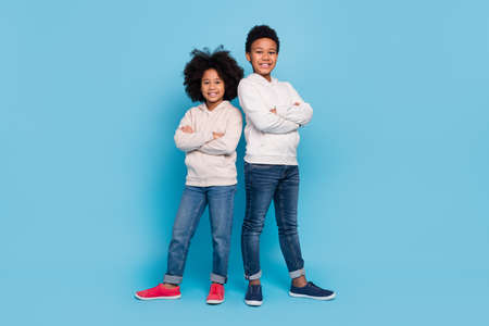 Full length body size view of attractive cheerful kids best support folded arms isolated over bright blue color backgroundの写真素材